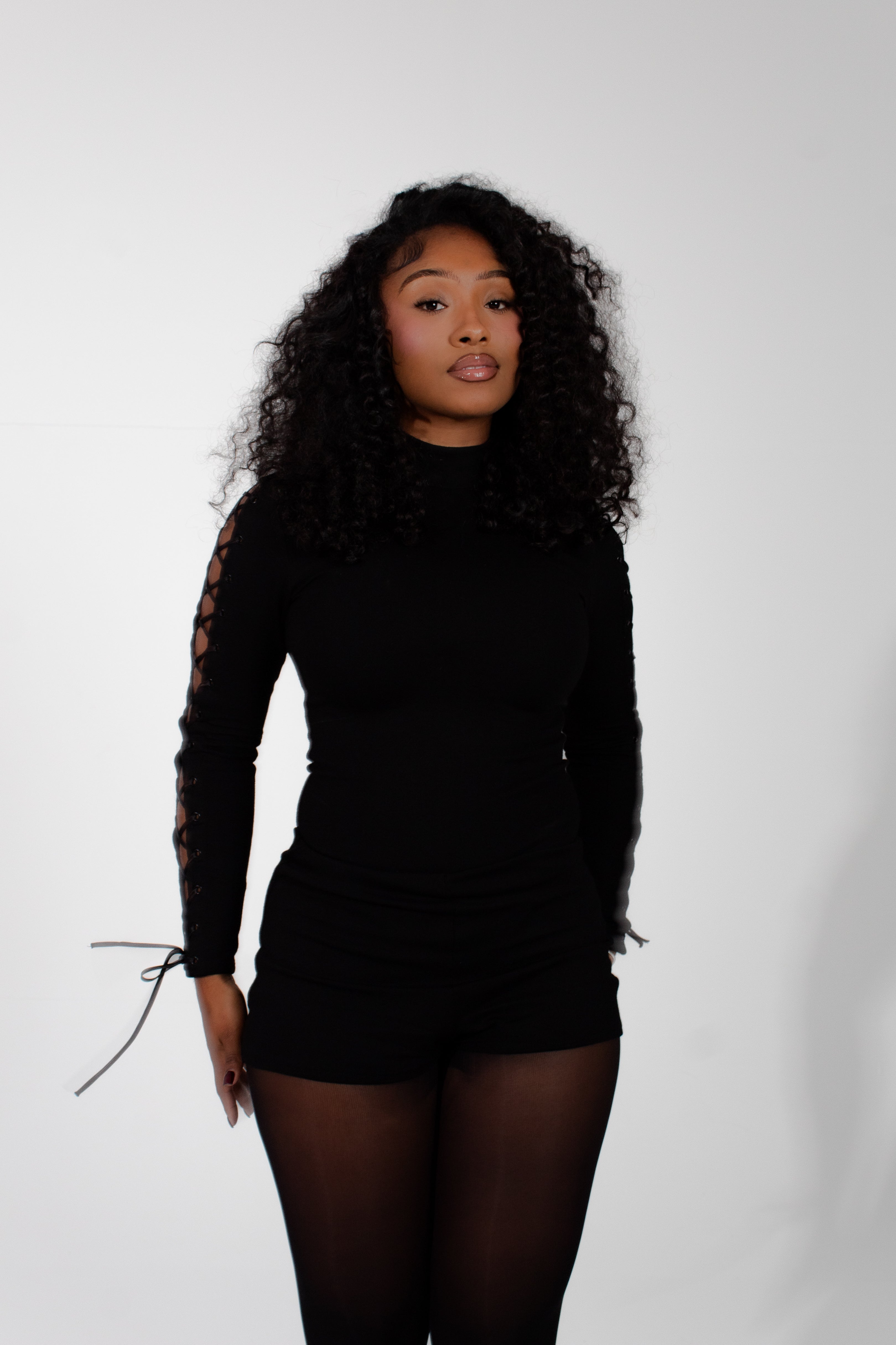 Model wearing mariposa bodysuit on a white background