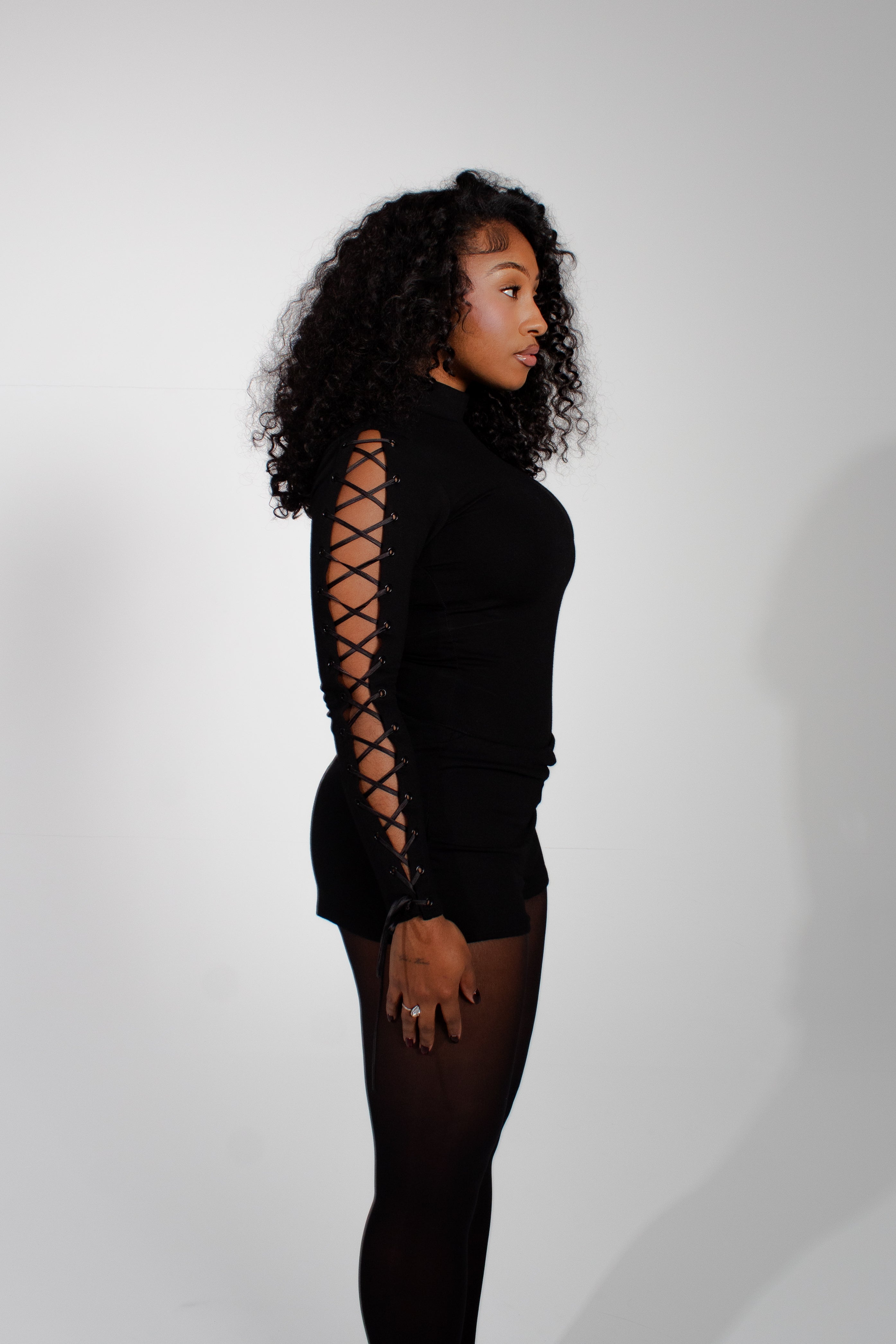 Model wearing mariposa bodysuit on a white background